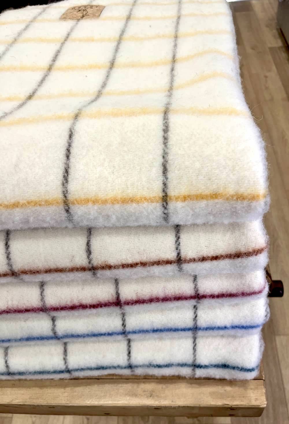 Plaid couverture vintage en 100% laine naturelle des Pyrénées, dimension 130x170, made in france, blanc écru, à carreaux, avec rayures bordeaux rosées et marrons brun.