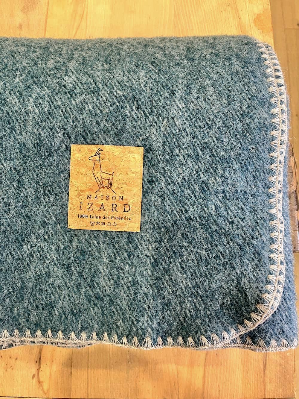 Plaid couverture, vert bleu paon, bords marrons, en 100% laine naturelle des Pyrénées, dimension 170x130, made in france